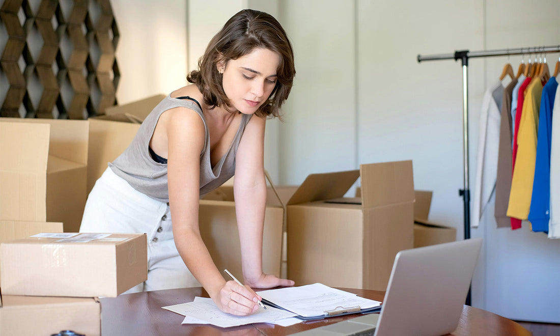 Laptop, packaging materials, and adult wellness products prepared for ecommerce fulfillment